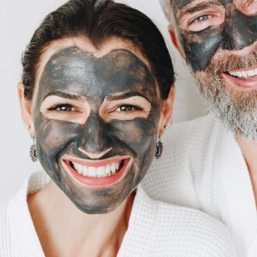 happy-couple-wearing-a-charcoal-mask-AXYBWQ9-scaled-1.jpg